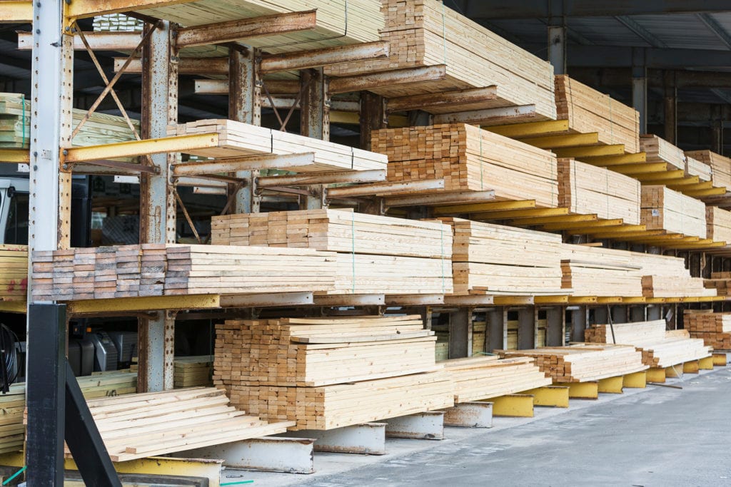 Stacks of lumber on shelves in a building
