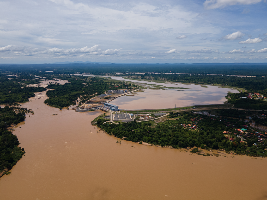 Aerial view of a river with the Don Sahong hydroelectric dam spanning a section of the river.