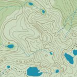 A topographic map of an entirely fictional location depicting rugged mountain peaks, lakes, rivers, and trails, with green colour indicating vegetation.