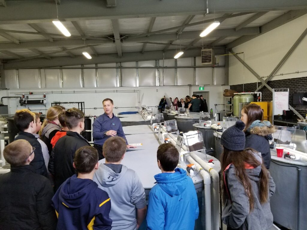 Dr. Pitcher talks to a group of students during a school visit at the Freshwater Restoration Ecology Centre.