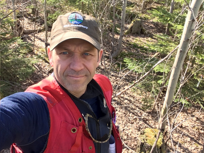 A photo of Dr. Nelson Thiffault in a forest.