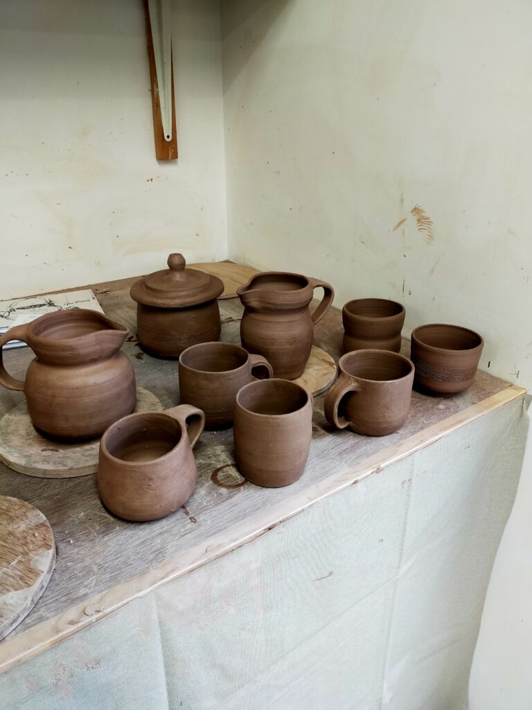 Brown clay mugs and pitchers
